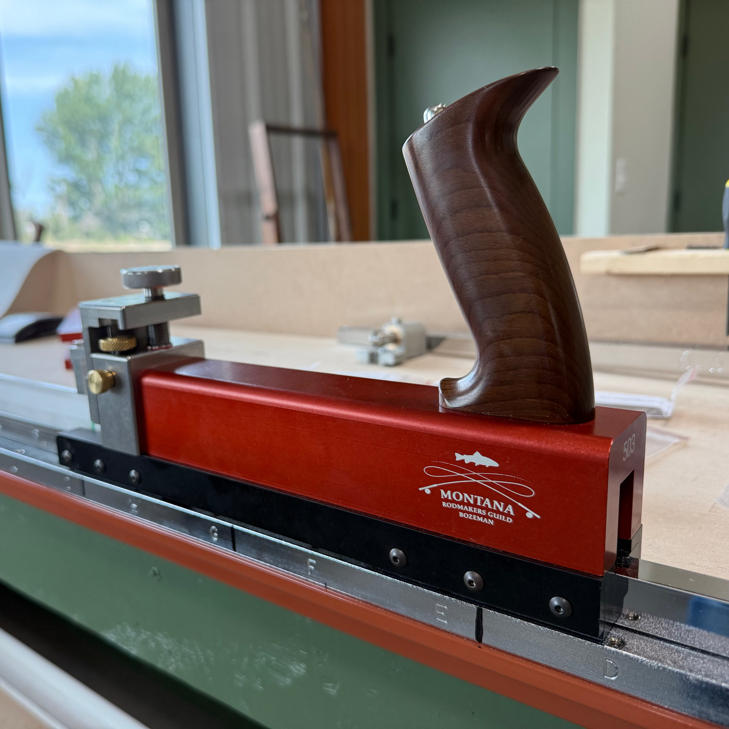 Wooden handle on a Montana brand tool with a blurred background